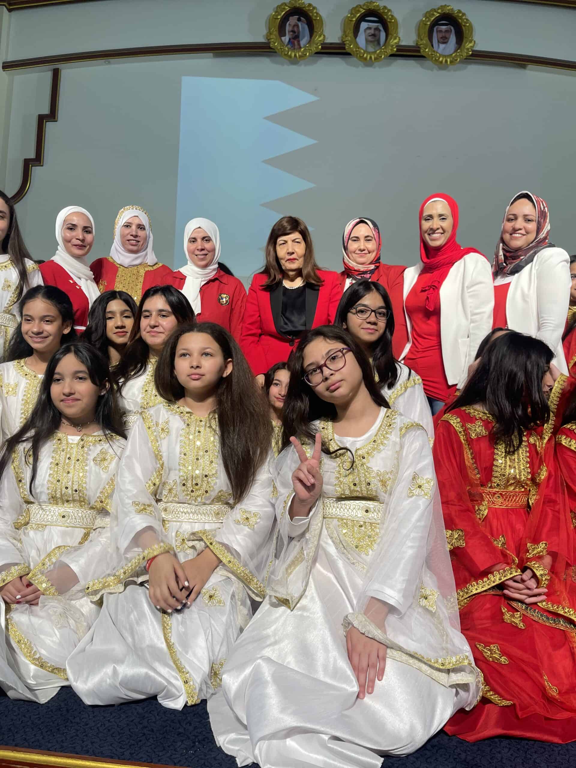 Group of students and teachers celebrating at MKS in traditional and school uniforms, highlighting cultural pride, education excellence, and school community in Bahrain.